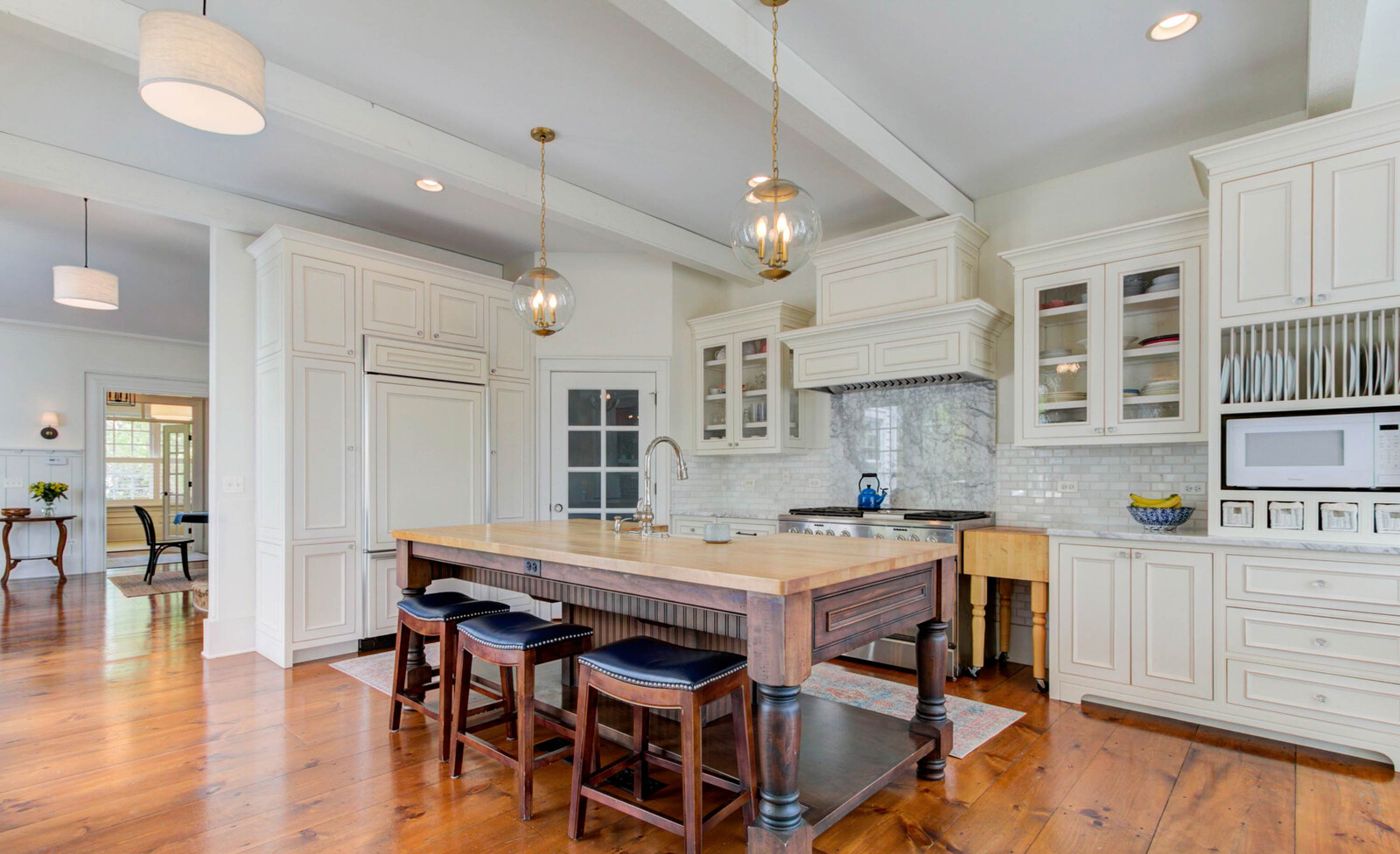 Kitchen with butcher-block island and marble backsplash