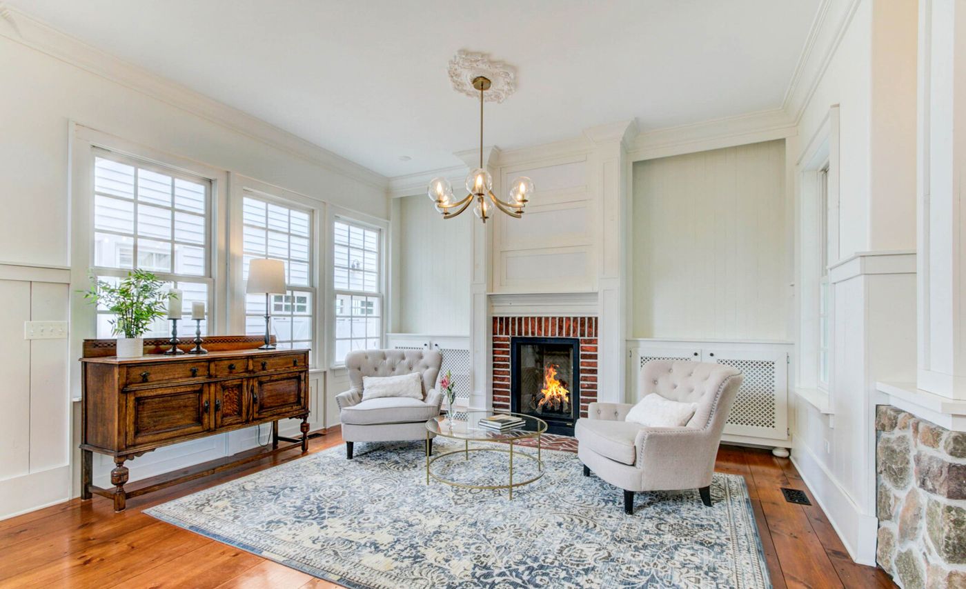 Sitting room with brick fireplace and hardwood floors