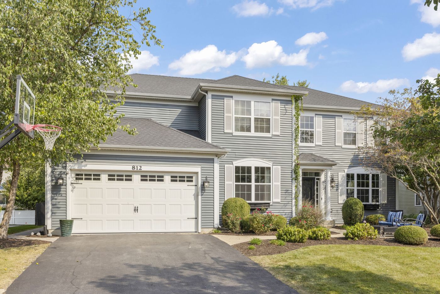 Two-story Illinois suburban home with landscaped front yard