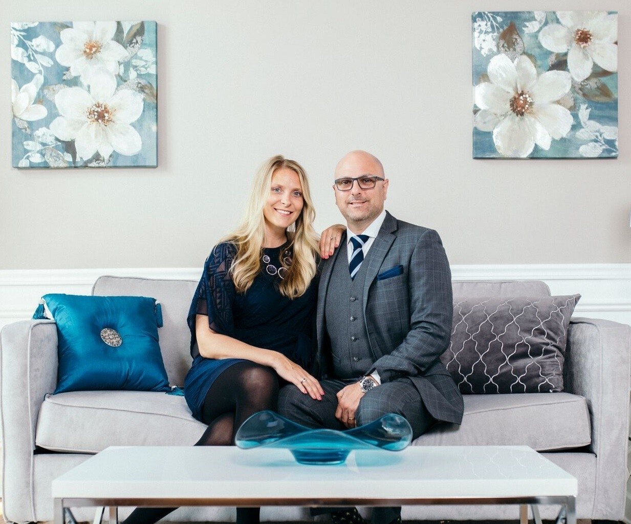 Steve Boyles and Andrea Boyles, Lead Brokers, seated together on a sofa